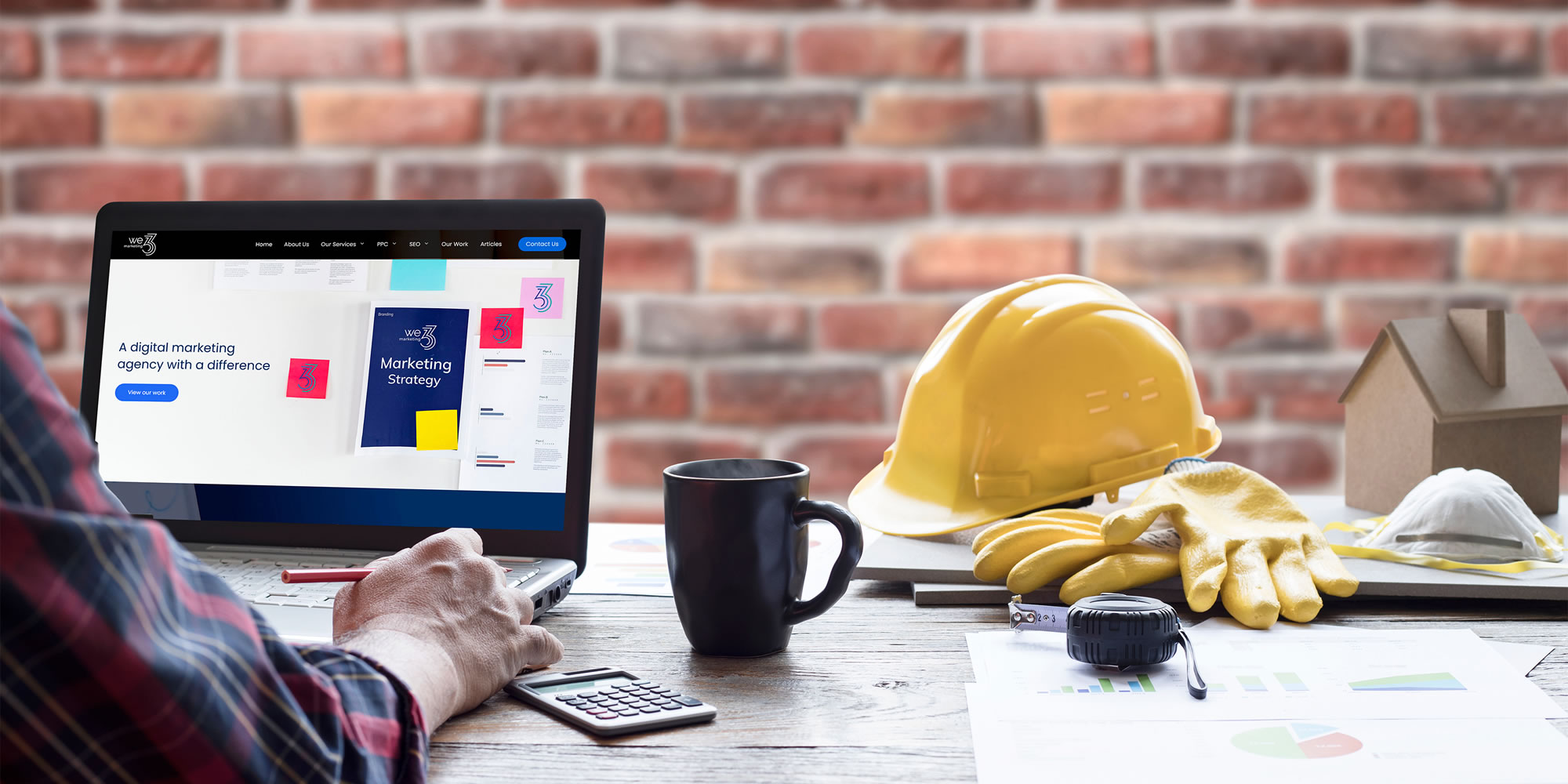 Trades person looking at We3marketing website on a laptop